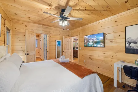 a view of a house with a yard and large trees