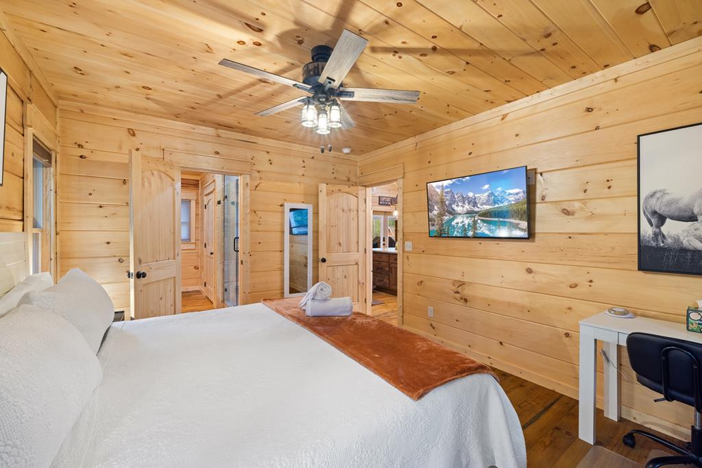 956 Lemmon Lane Ellijay, GA 30540 - Photo 49 of 60 a bedroom with a bed and a flat screen tv