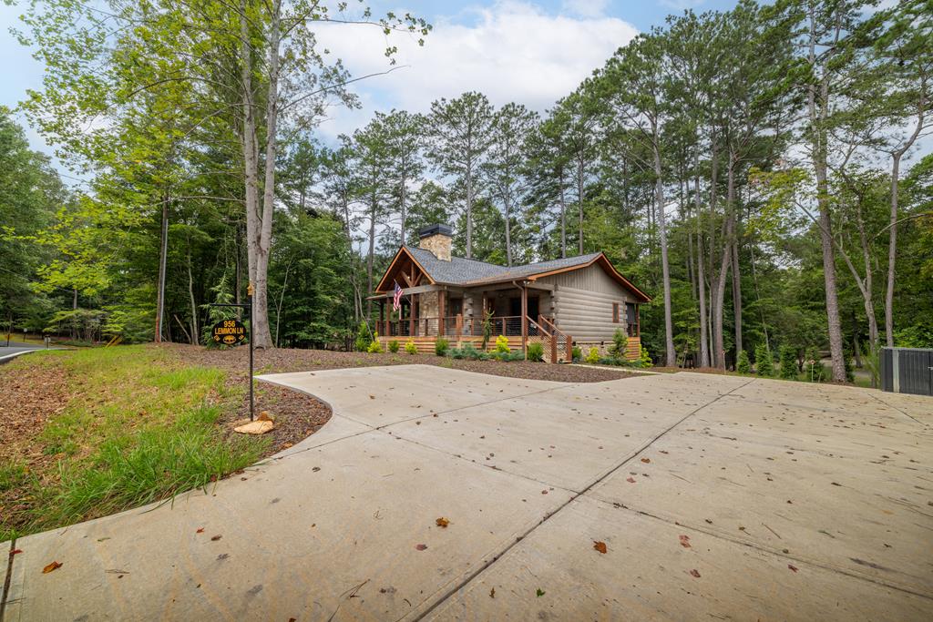 956 Lemmon Lane Ellijay, GA 30540 - Photo 56 of 60 a front view of a house with a yard and trees