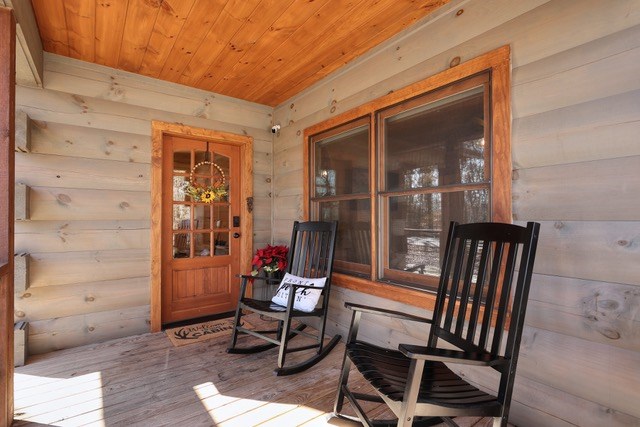 956 Lemmon Lane Ellijay, GA 30540 - Photo 7 of 60 a view of a porch with chairs and couches with wooden floor