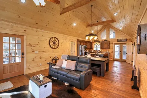 a view of a living room with furniture and a fireplace