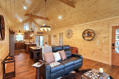 a view of a dining room with furniture a chandelier and wooden floor