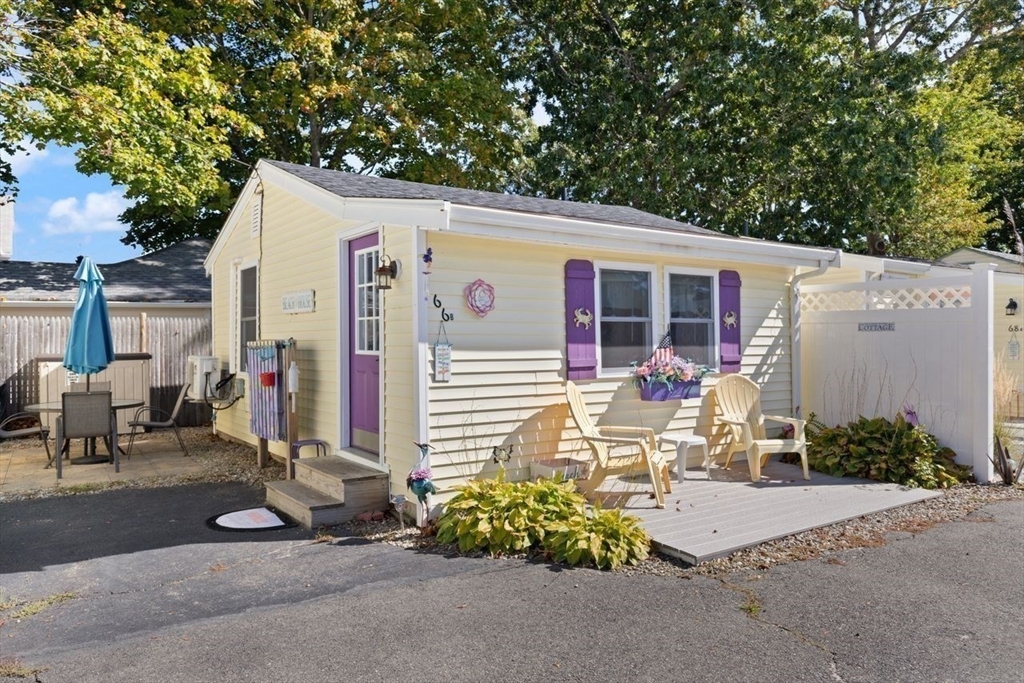 66 Bayview Street Wareham, MA 02571 - Photo 12 of 37 a view of a patio with table and chairs and potted plants