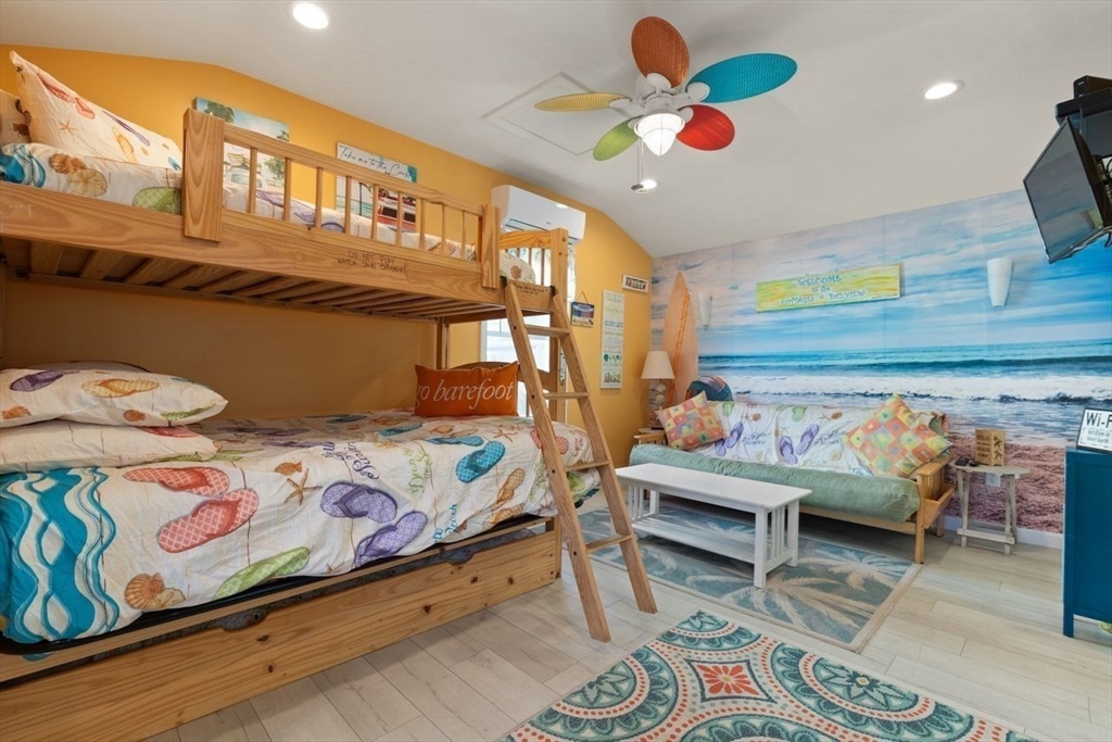 66 Bayview Street Wareham, MA 02571 - Photo 15 of 37 a bedroom with a bed and a chandelier