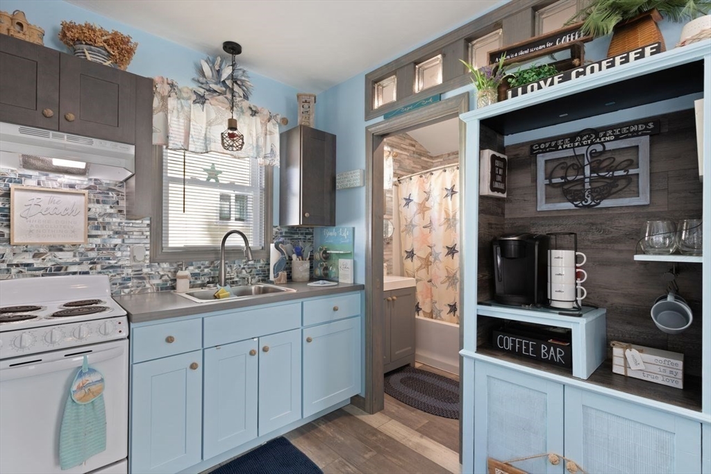 66 Bayview Street Wareham, MA 02571 - Photo 20 of 37 a kitchen with stainless steel appliances a stove a sink and a refrigerator