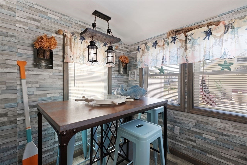 66 Bayview Street Wareham, MA 02571 - Photo 21 of 37 a dining room with a wooden table and chairs