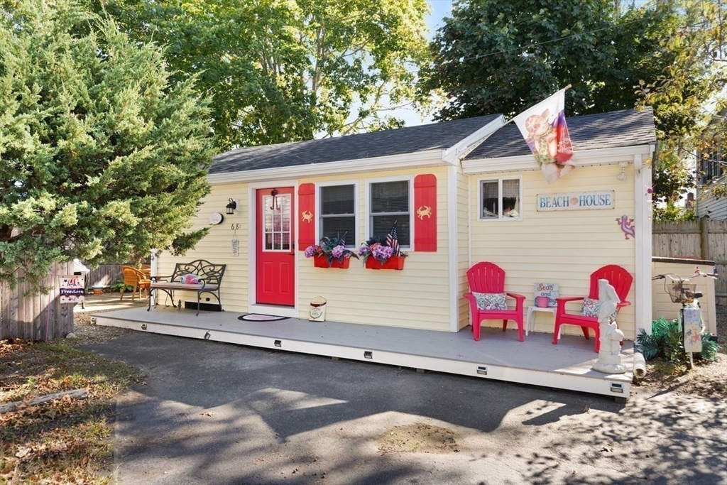 66 Bayview Street Wareham, MA 02571 - Photo 23 of 37 a view of a white house with a small yard and sitting area