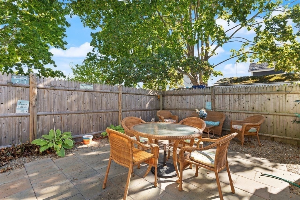 66 Bayview Street Wareham, MA 02571 - Photo 26 of 37 a view of a chairs and table in the back yard