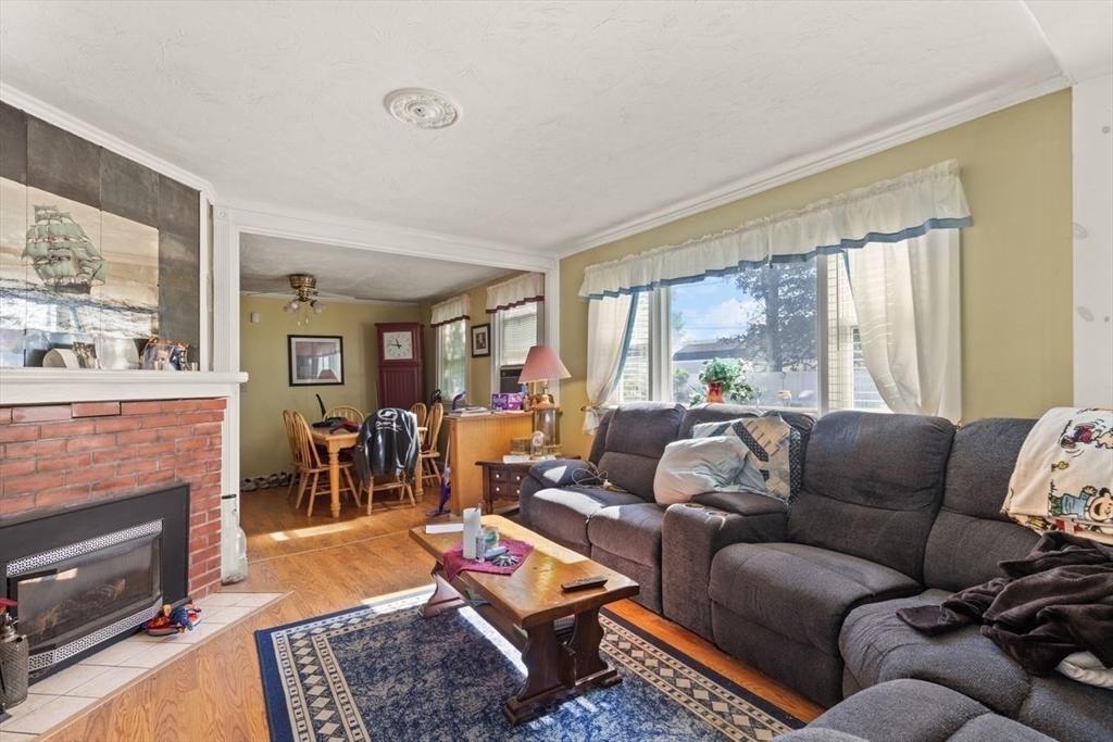 66 Bayview Street Wareham, MA 02571 - Photo 29 of 37 a living room with furniture fireplace and a large window