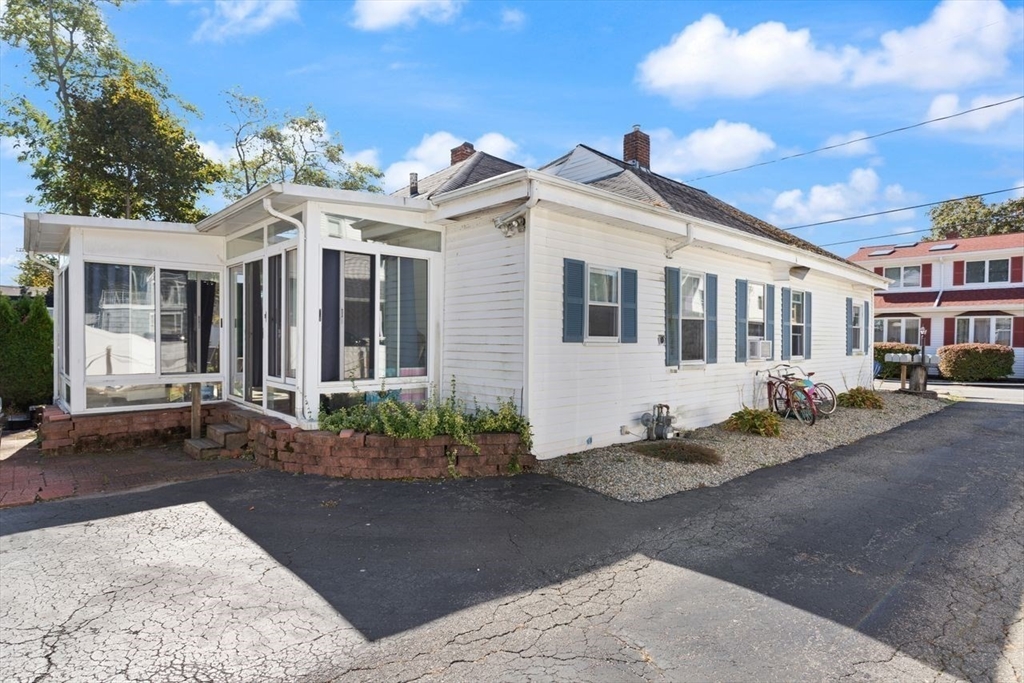 66 Bayview Street Wareham, MA 02571 - Photo 3 of 37 a view of a white house with large windows and potted plants