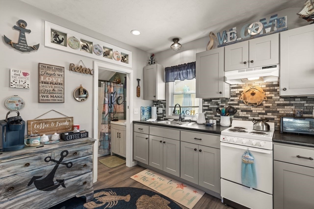 66 Bayview Street Wareham, MA 02571 - Photo 7 of 37 a kitchen with cabinets appliances and a window
