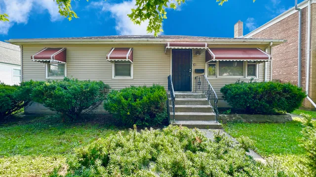 a front view of a house with a garden
