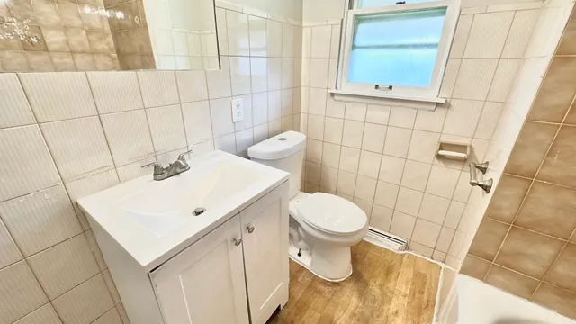 a bathroom with a sink a toilet and mirror
