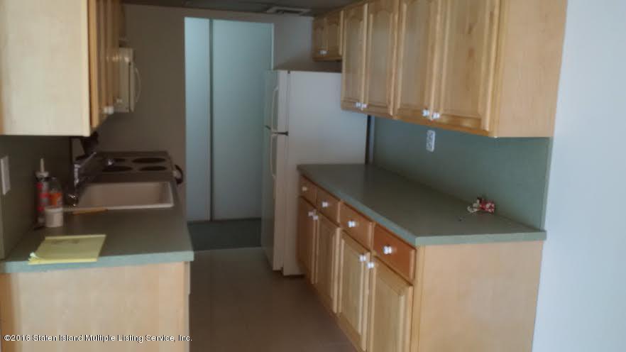 5 Windham Loop, Unit 1J Staten Island, NY 10314 - Photo 4 of 8 a kitchen with a refrigerator and a stove