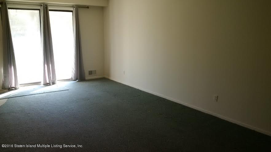 5 Windham Loop, Unit 1J Staten Island, NY 10314 - Photo 5 of 8 an empty room with a window