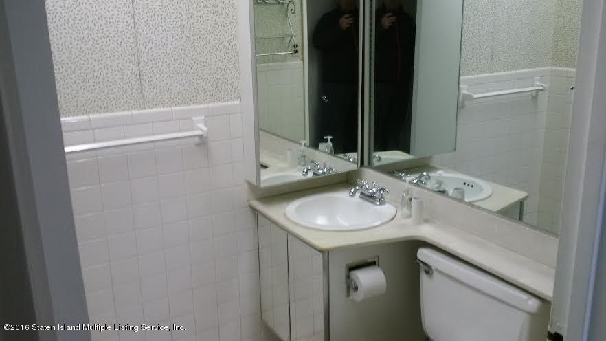 5 Windham Loop, Unit 1J Staten Island, NY 10314 - Photo 6 of 8 a bathroom with a sink and a mirror