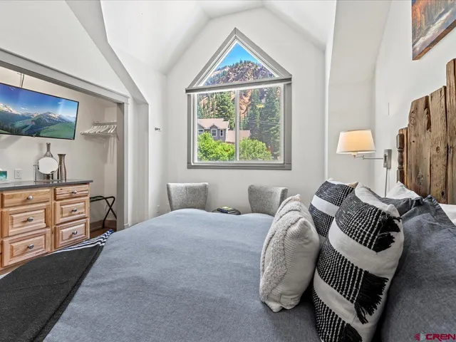 a bedroom with furniture and a window