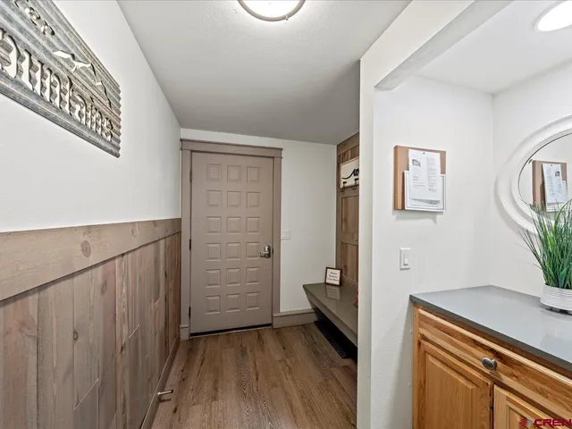a view of an entryway with wooden floor