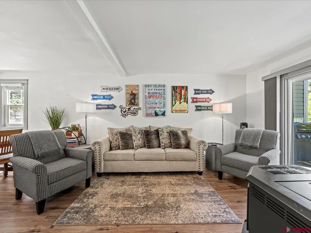 a living room with furniture and a rug