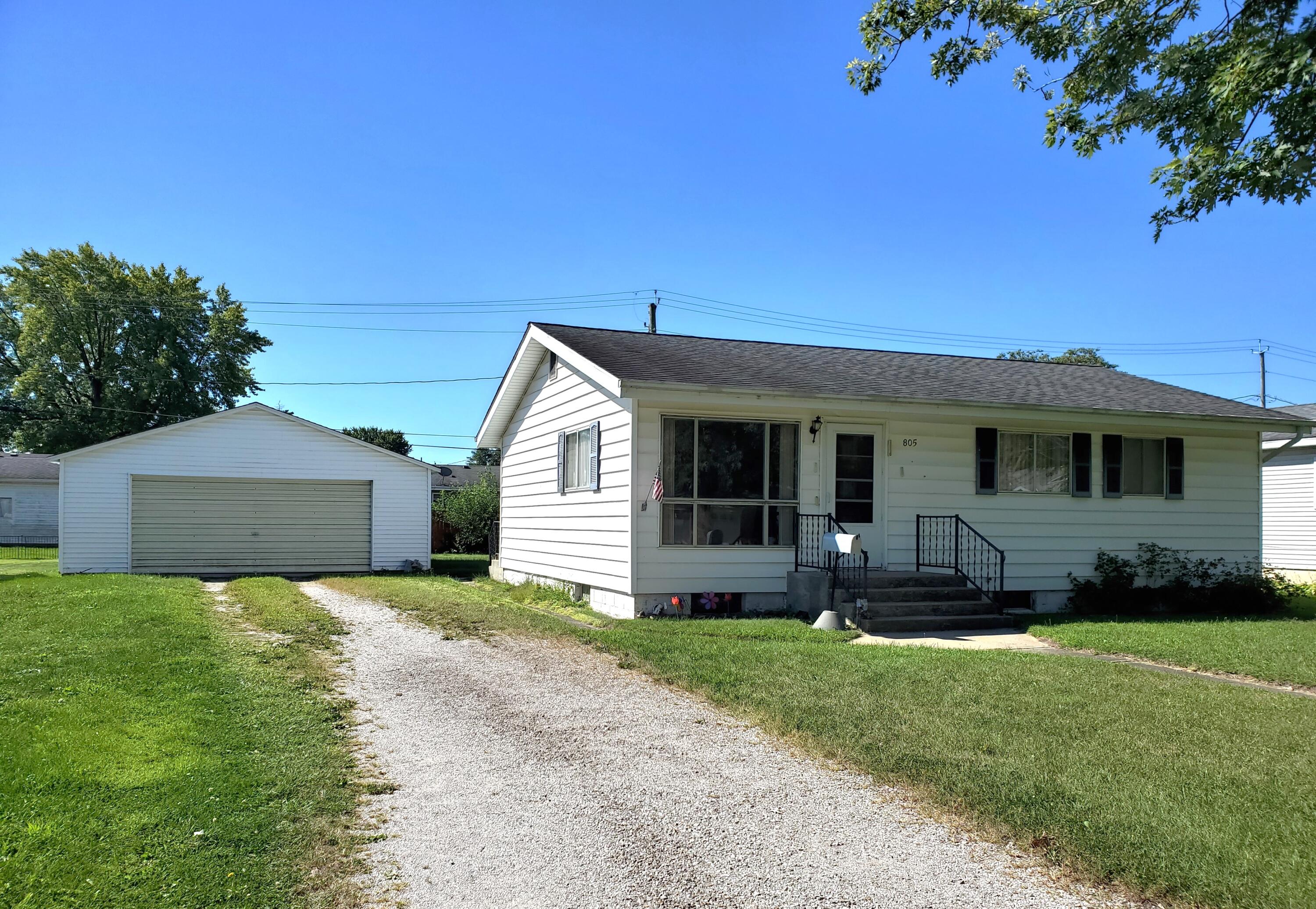 a front view of a house with a yard and porch