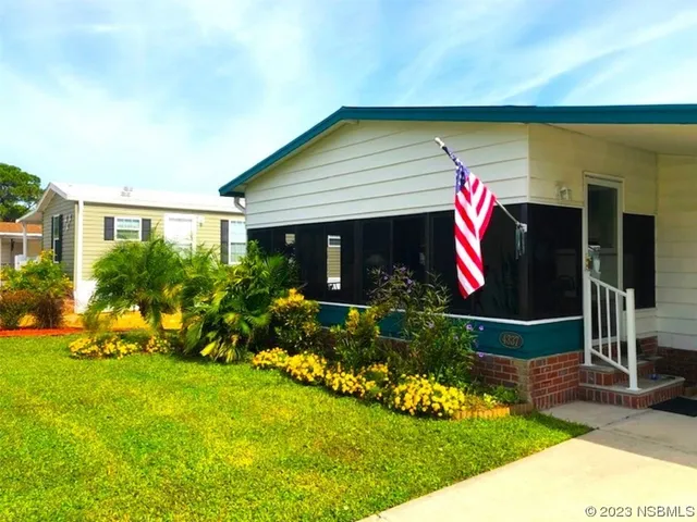 a front view of house with yard and outdoor seating