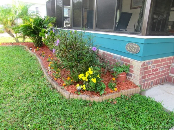 a sign that is in front of flowers