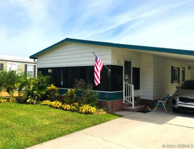 a front view of house with yard and outdoor seating