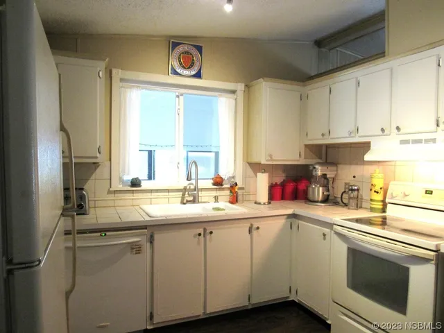 a kitchen with a sink cabinets and window