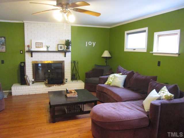 207 Plainview Avenue Raleigh, NC 27604 - Photo 11 of 25 Living room with updated hardwoods! Crank out windows! Real masonry fireplace with raised hearth! Has been cleaned in the past and is in working order! A great room for the holidays!!