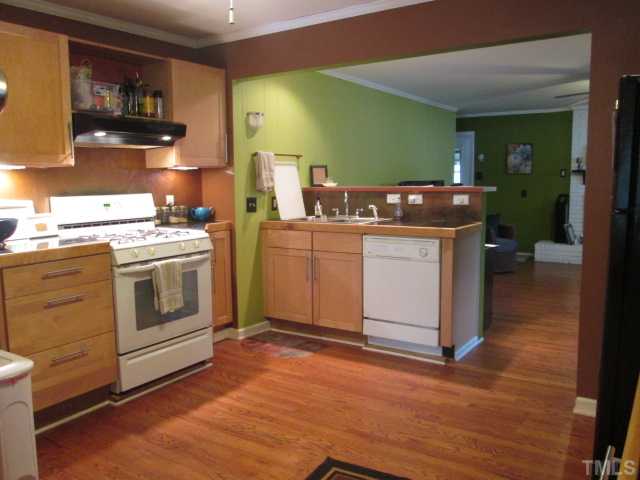 207 Plainview Avenue Raleigh, NC 27604 - Photo 12 of 25 Completely updated Kitchen with Granite Style tile counter tops! Updated Maple cabinets with brush nickel hardware! Very cool, COPPER back splash with under cabinet lighting! Hardwood floors are everywhere in this home except the bathrooms!