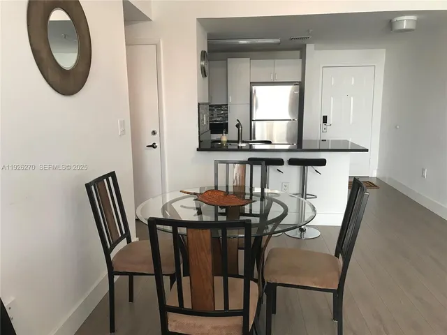 a view of a dining room with furniture and window