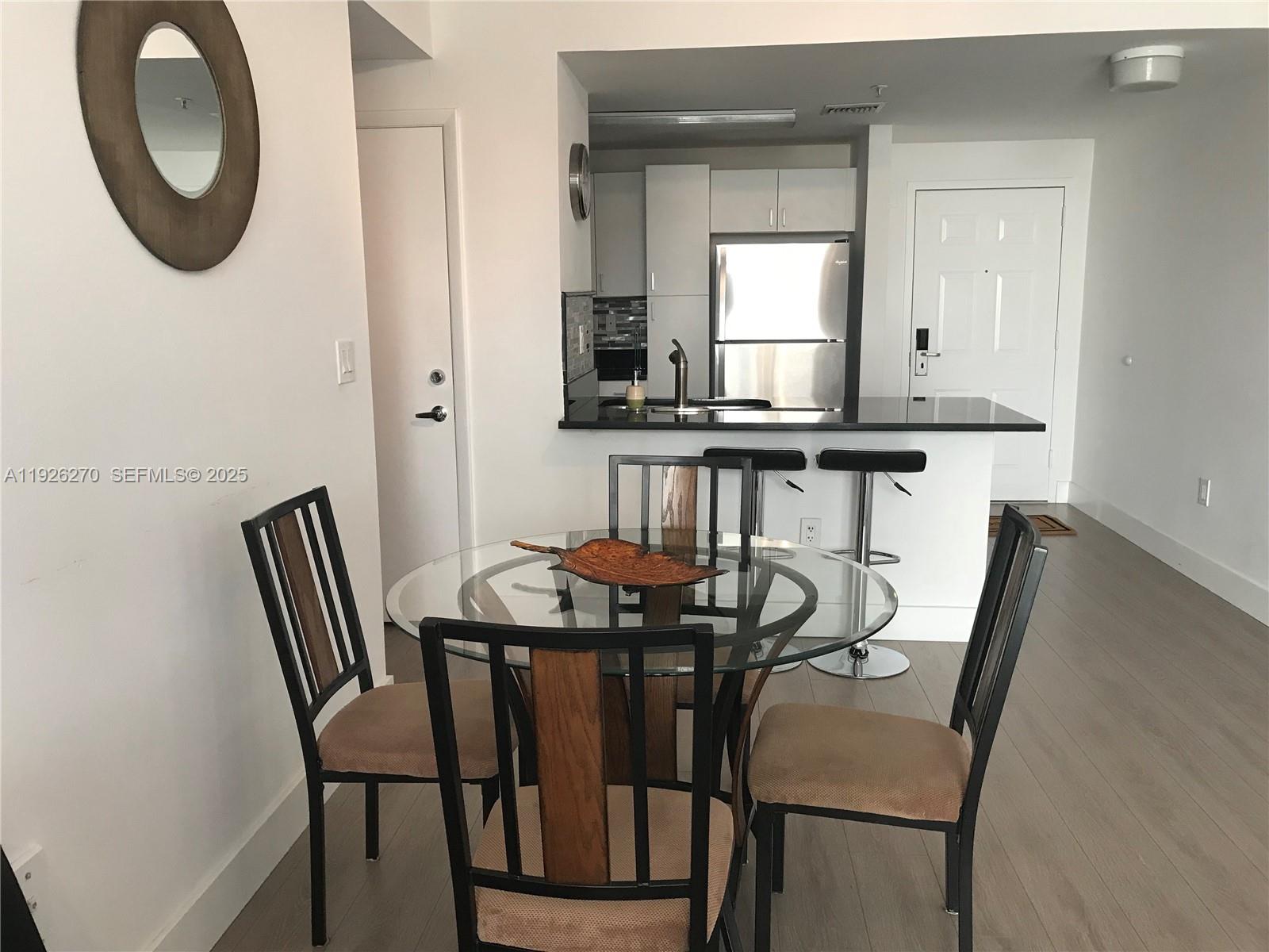 185 Southeast 14th Terrace, Unit 802 Miami, FL 33131 - Photo 13 of 19 a view of a dining room with furniture and window