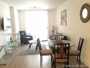 a view of a dining room with furniture and a chandelier