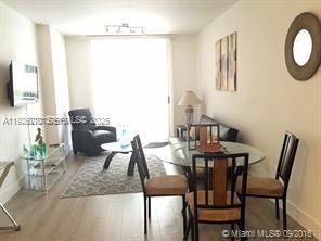 185 Southeast 14th Terrace, Unit 802 Miami, FL 33131 - Photo 14 of 19 a view of a dining room with furniture and a chandelier