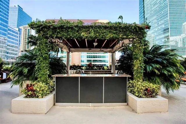 a view of a house with a yard and potted plants