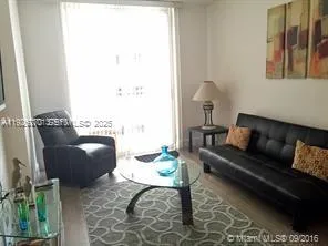 a living room with furniture and a window