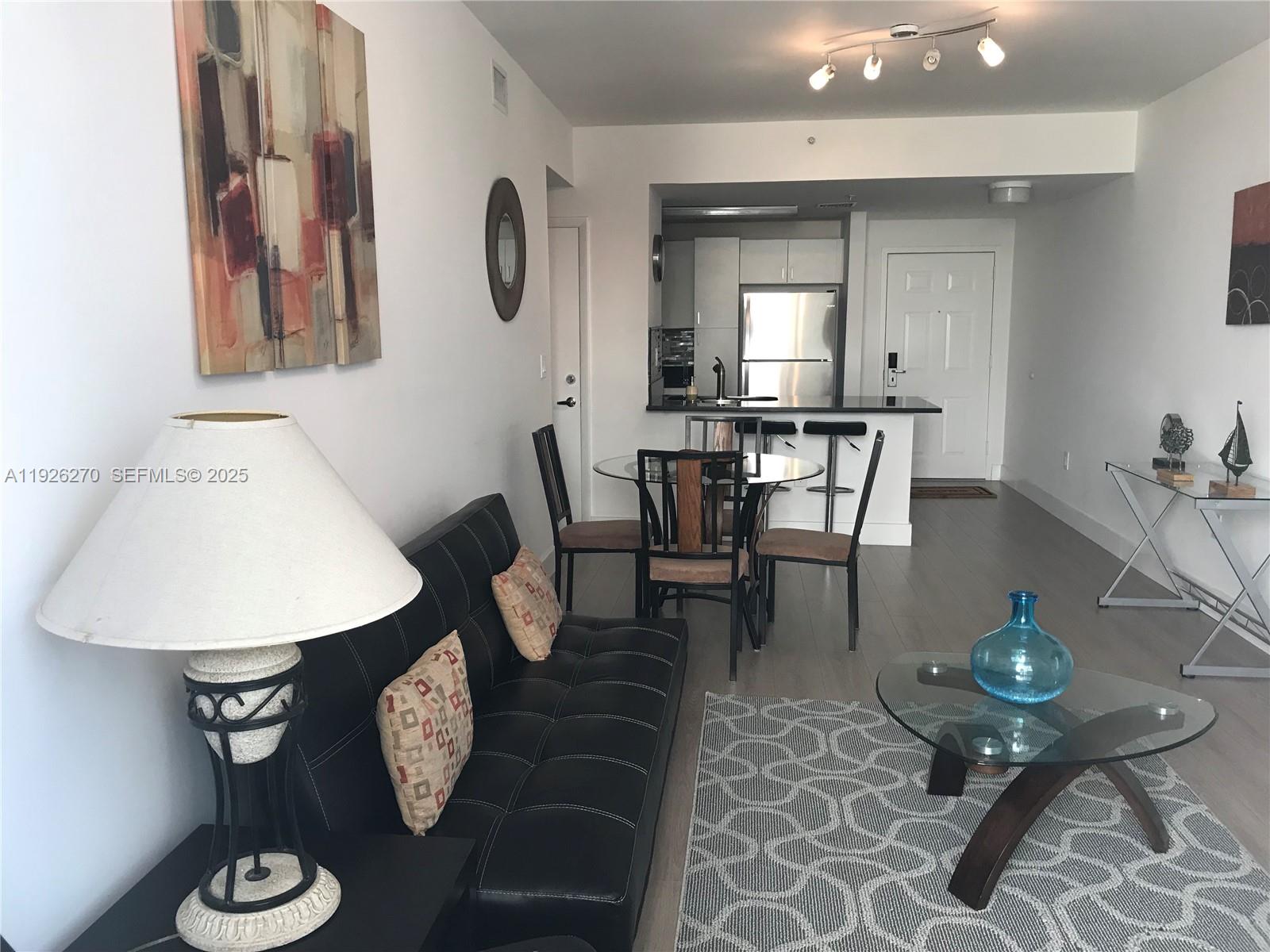 185 Southeast 14th Terrace, Unit 802 Miami, FL 33131 - Photo 5 of 19 a view of a dining room with furniture