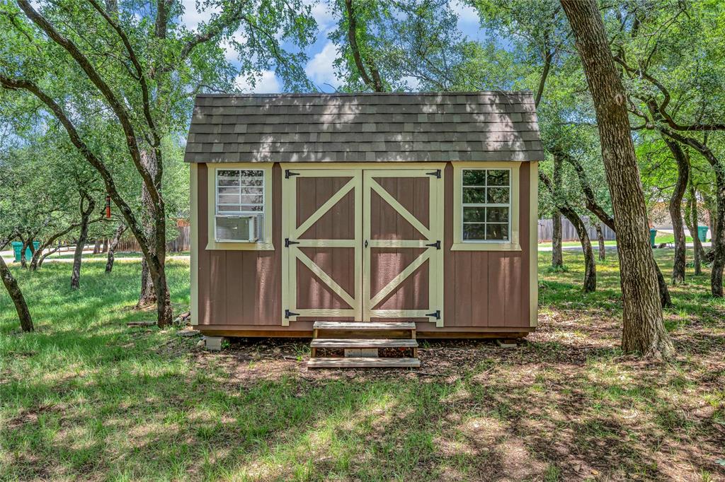 37 Bluebonnet Loop Morgan's Point Resort, TX 76513 - Photo 34 of 38 Detached storage shed featuring wood-finish siding, double barn doors, and two windows
