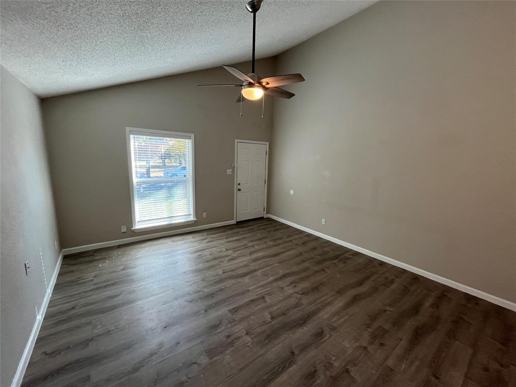 5827 Columbia Avenue Dallas, TX 75214 - Photo 2 of 15 a view of a room with wooden floor and ceiling fan