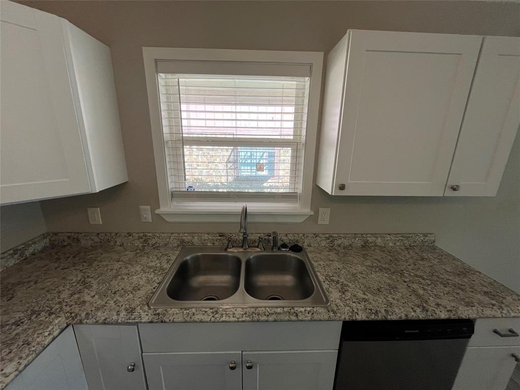 5827 Columbia Avenue Dallas, TX 75214 - Photo 4 of 15 a kitchen with granite countertop a sink a stove and cabinets