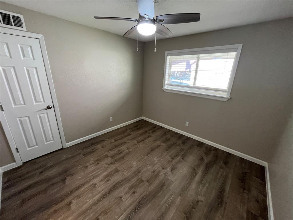 5827 Columbia Avenue Dallas, TX 75214 - Photo 6 of 15 a view of an empty room with wooden floor and a window