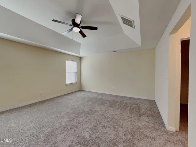 a view of a room with wooden floor and a window