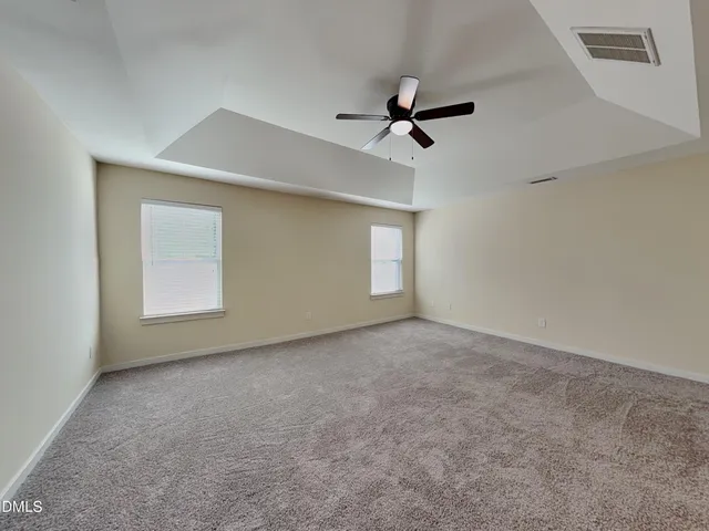a view of empty room with ceiling fan