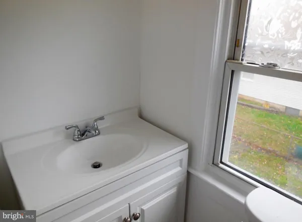 a bathroom with a sink and a window