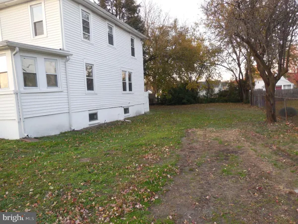 a view of a backyard with large trees