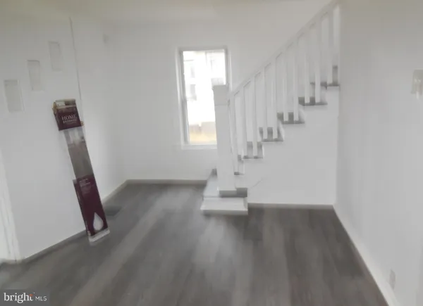 a view of entryway with stairs and wooden floor