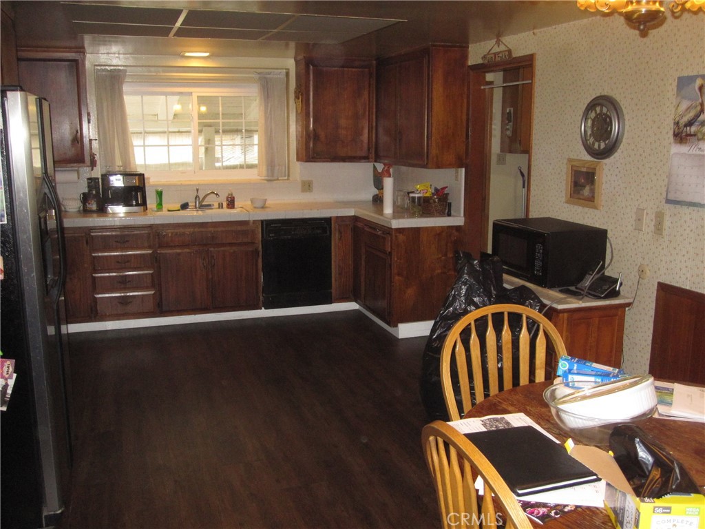 8532 Cedar Drive Buena Park, CA 90620 - Photo 18 of 40 a kitchen with stainless steel appliances a sink a stove a refrigerator and cabinets