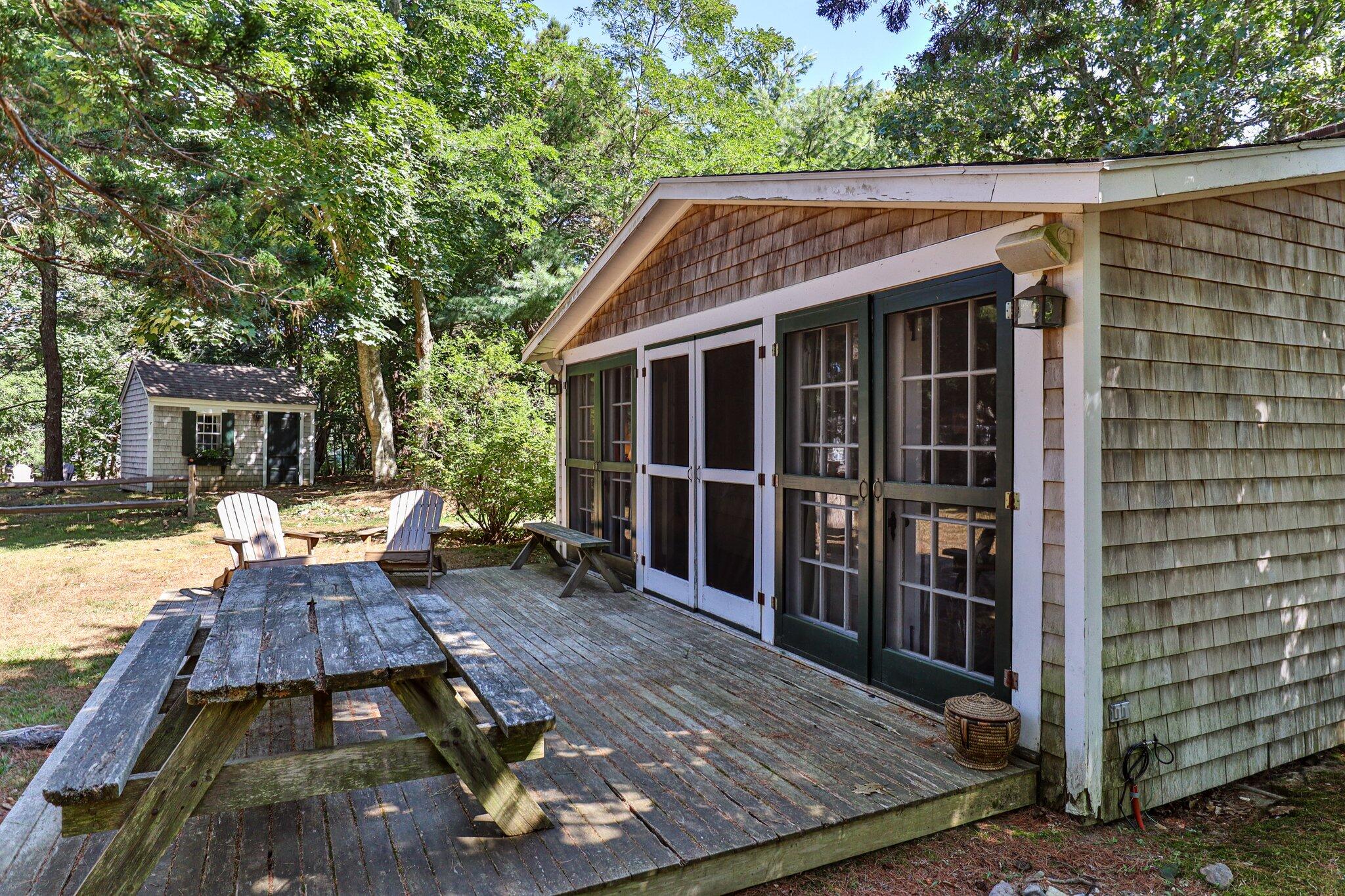 1975 State Highway, Unit 9 Eastham, MA 02642 - Photo 2 of 23 a view of a wooden deck and a yard with back yard