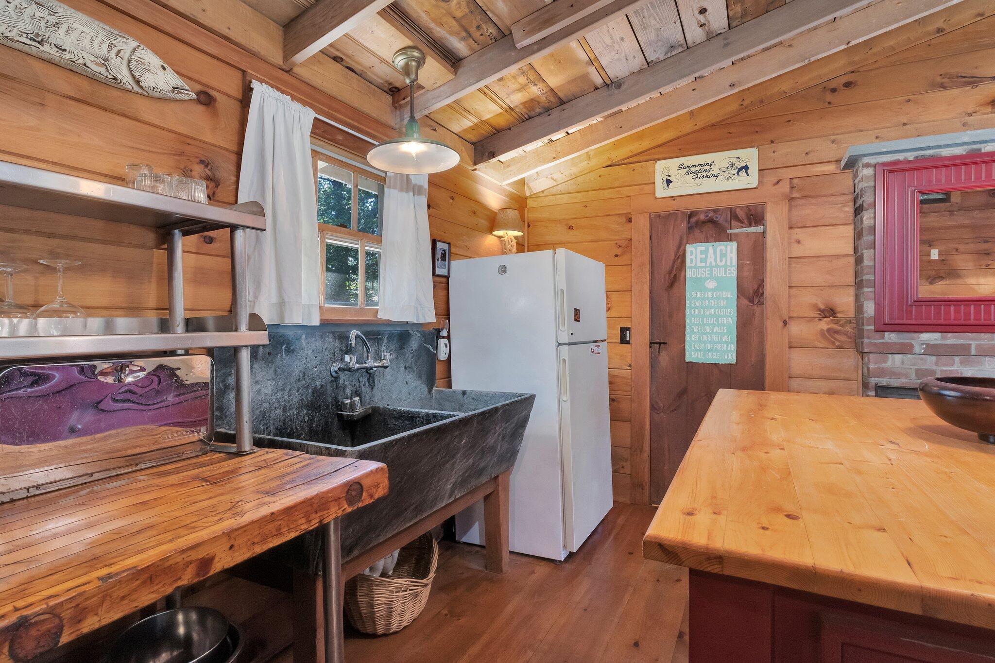 1975 State Highway, Unit 9 Eastham, MA 02642 - Photo 4 of 23 a room with stainless steel appliances kitchen island granite countertop furniture and a refrigerator