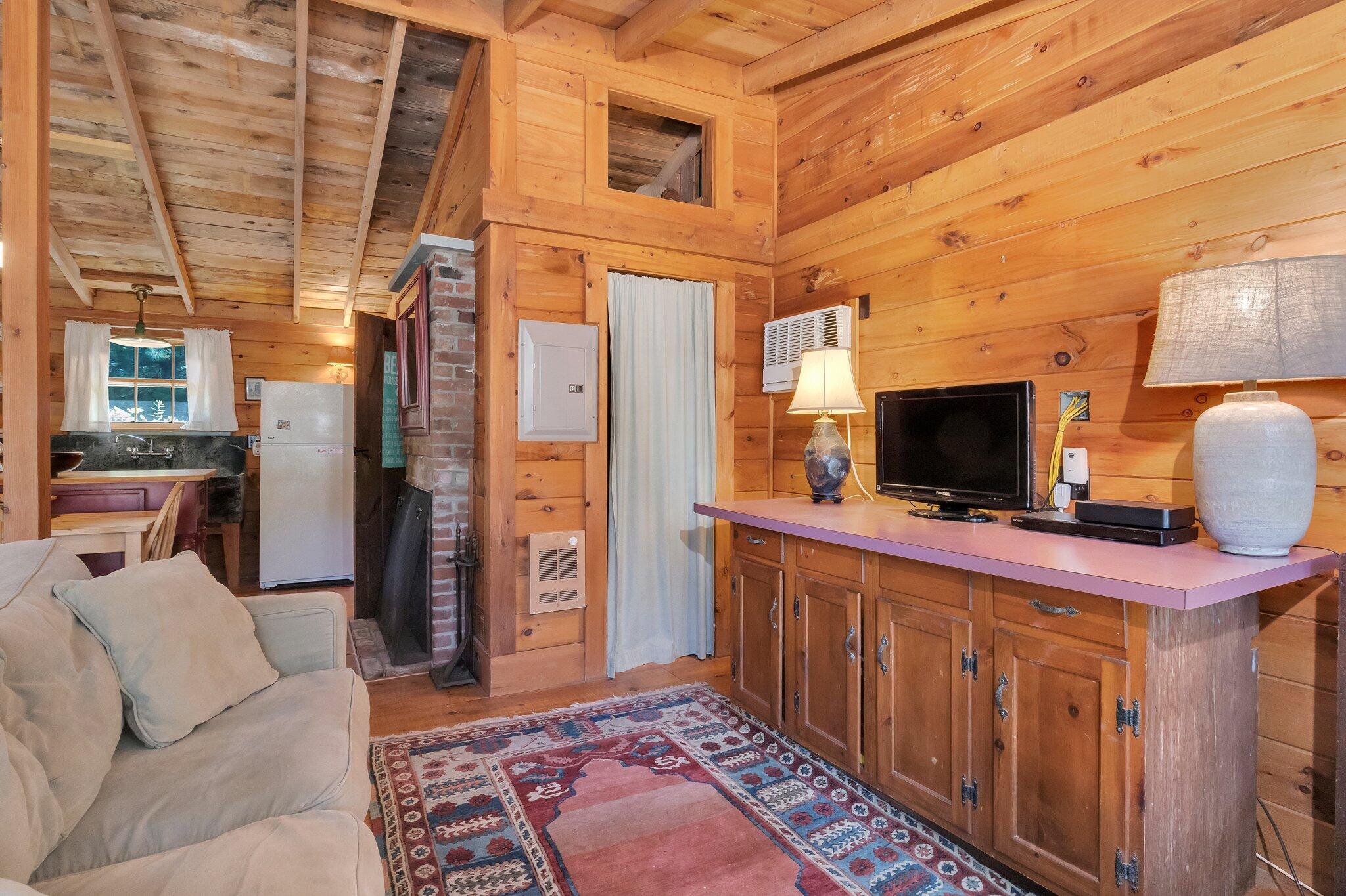 1975 State Highway, Unit 9 Eastham, MA 02642 - Photo 8 of 23 a living room with furniture and a flat screen tv